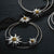 Sterling Silver Stud Earrings with three polished Bicolor Edelweiss on two satin-finished asymmetrical Hoops by Gexist®