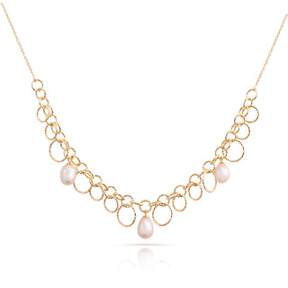 Sterling Silver necklace with yellow gold plating and a shiny, diamond-cut finish, featuring multiple round rings of different sizes and teardrop-shaped freshwater pearls by Gexist®