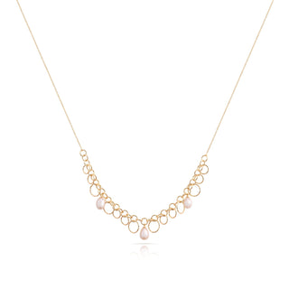 Sterling Silver necklace with yellow gold plating and a shiny, diamond-cut finish, featuring multiple round rings of different sizes and teardrop-shaped freshwater pearls by Gexist®