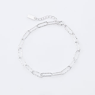 Sterling silver bracelet featuring several shiny rectangular rings with a hammered finish by Gexist®