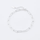 Sterling silver bracelet featuring several shiny rectangular rings with a hammered finish by Gexist®
