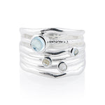 Sterling silver ring with 3mm and 6mm blue topazes on several bands by Gexist®
