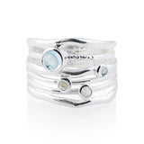 Sterling silver ring with 3mm and 6mm blue topazes on several bands by Gexist®