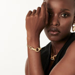 Bracelet in Sterling Silver with yellow gold plating made of a triple chain with oval rings of different sizes and finishes between shiny and brushed by Gexist®