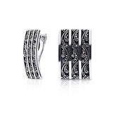 Sterling Silver clip-on earrings in the shape of a slightly curved rectangle, with pretty shiny designs, which embrace the oxidised part of the jewel by Gexist®