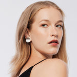 Sterling Silver clip-on earrings in the shape of thick, slightly curved discs with a satin finish by Gexist®