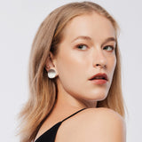 Sterling Silver clip-on earrings in the shape of thick, slightly curved discs with a satin finish by Gexist®