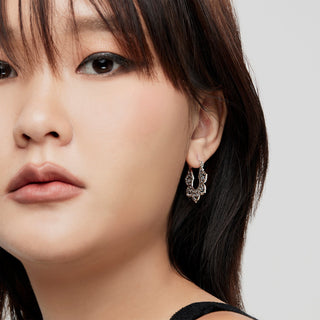 Sterling silver earrings in the shape of a hanging leaf by Gexist®