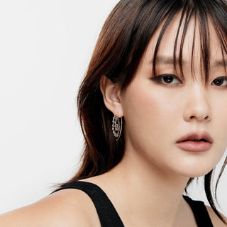 Sterling silver earrings in the shape of an oxidised spiral by Gexist®