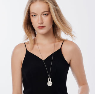 Sterling silver necklace with pendant consisting of an oval shaped element linked to a disc, both with a brushed finish by Gexist®