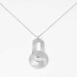 Sterling silver necklace with pendant consisting of an oval shaped element linked to a disc, both with a brushed finish by Gexist®