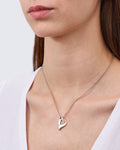 Sterling silver pendant in the shape of a spiral heart by Gexist®