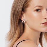 Sterling silver stud earrings in an asymmetric spiral shape with a brushed finish by Gexist®